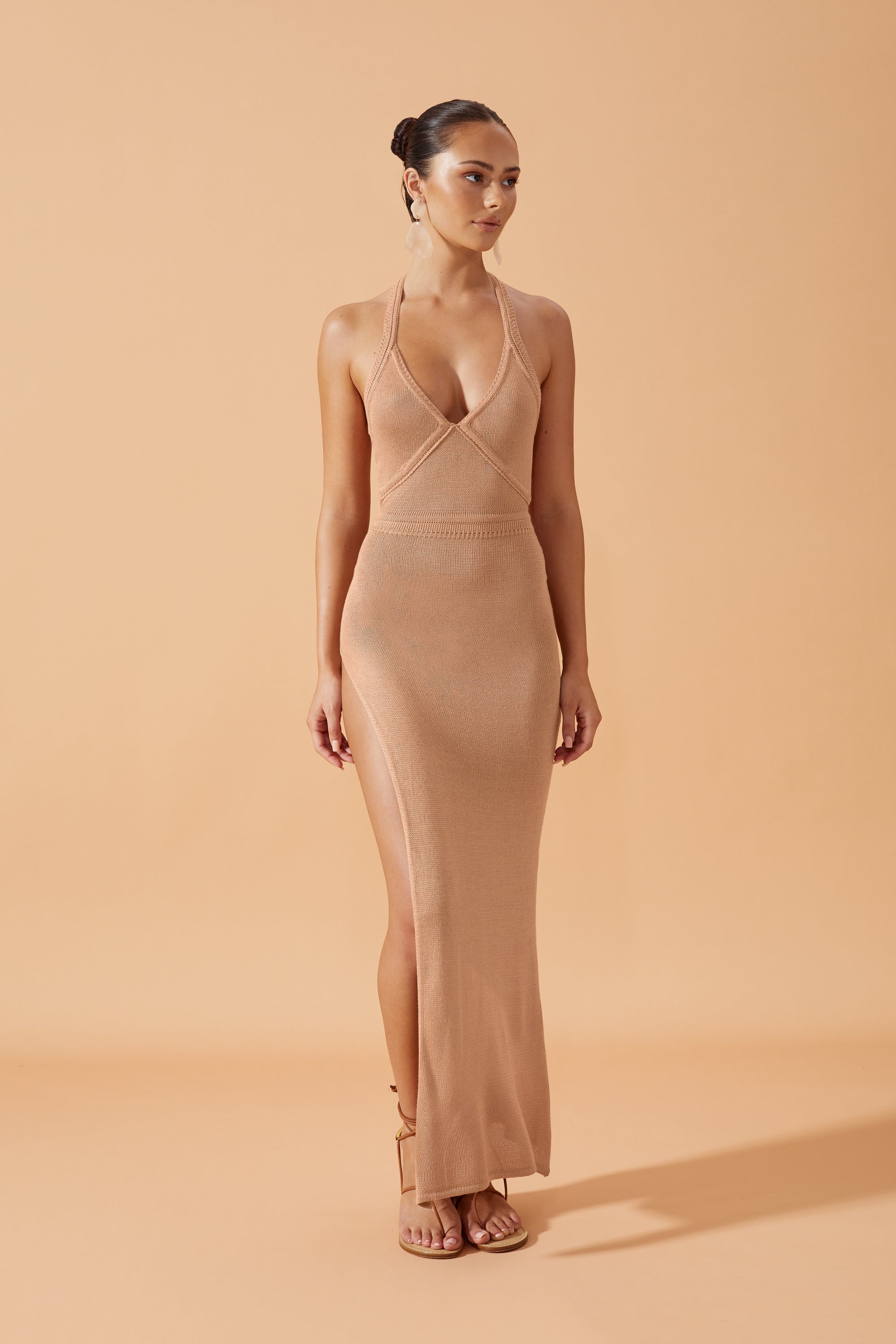 Flook The Label Alhoi  Knit Long Dress with side slit in Terracotta,  worn with drop earrings  frontview