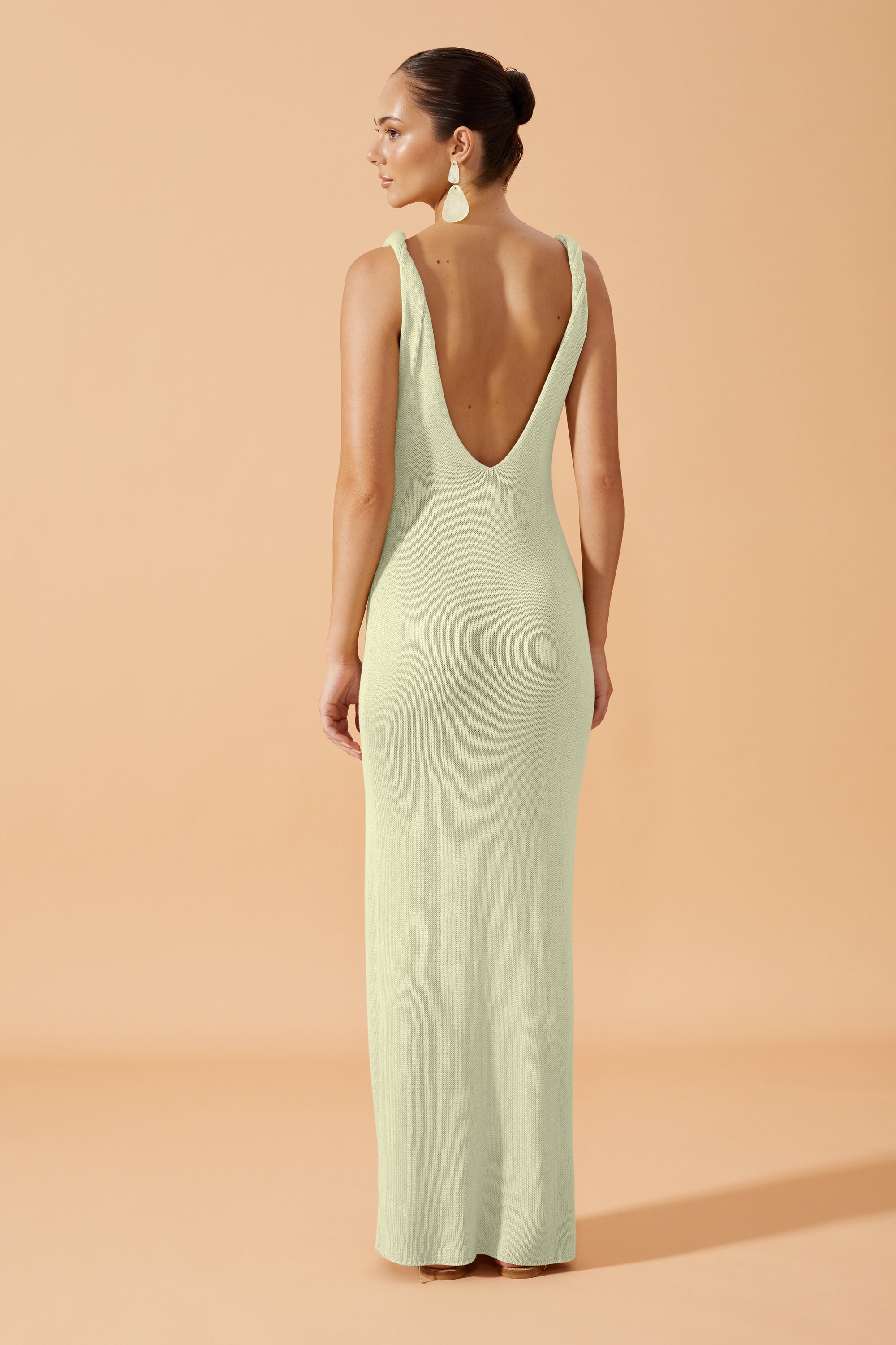 Flook The Label Anaya  Long Dress with side slit in  Pistachio,  worn with drop earrings back view