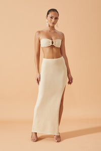 Flook The Label Chika Knit Long Skirt in Sand,with side slit   worn with drop resin earrings, front view