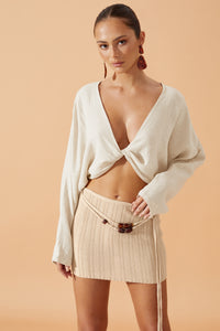 Flook The Label Dallis Knit Ribbed Mini Skirt  in Caramel worn with resin dropp earrings, front view