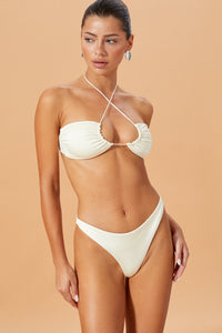 A model wearing a white bikini top and bottom, solid white color.