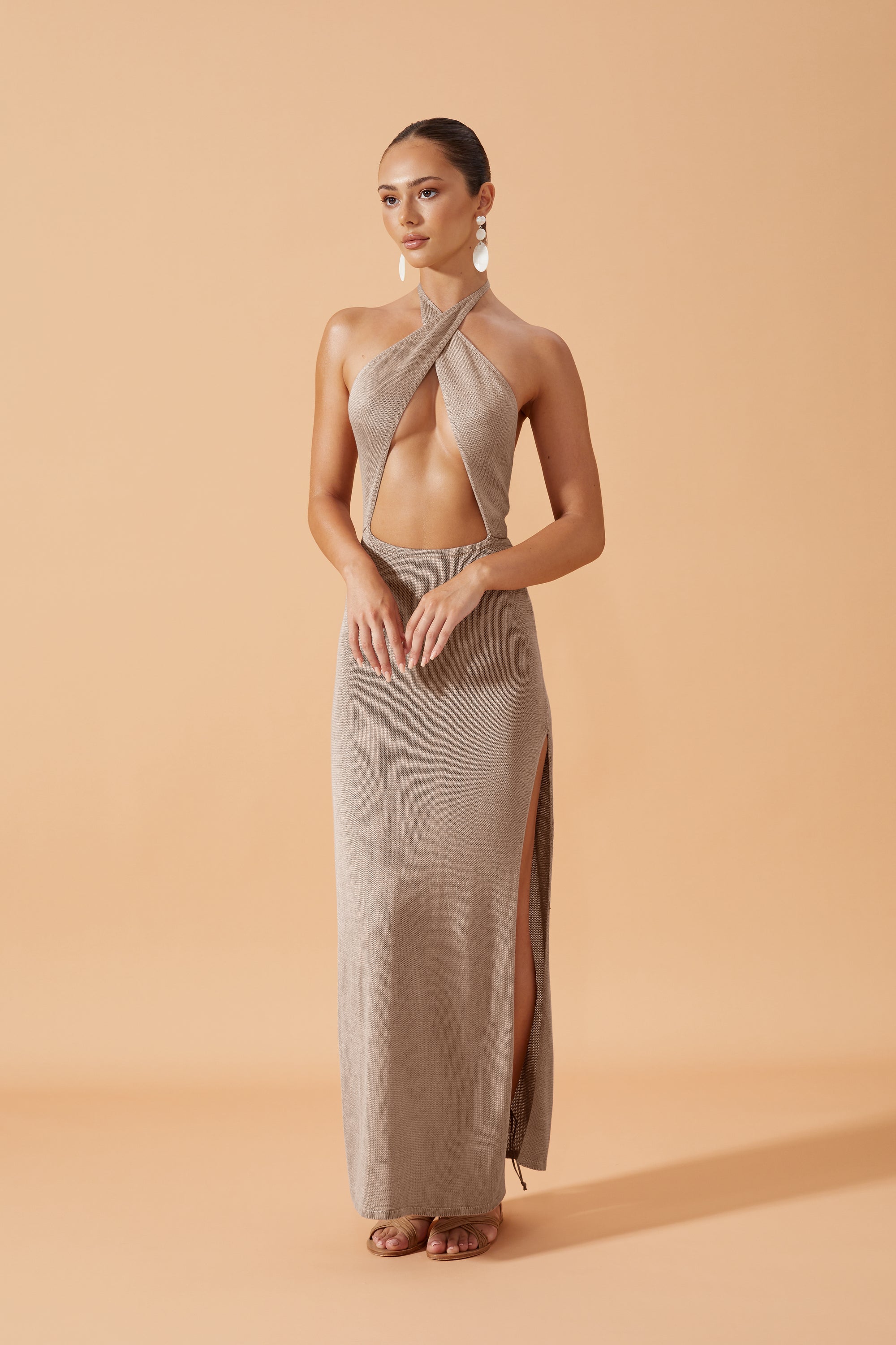 Flook The Label Lua Knit Long Dress in Taupe. Open front crossed at the neck and slits on both sides. Front ViewFlook The Label Lua Knit Long Dress in Taupe. Open front crossed at the neck and slits on both sides. Front View